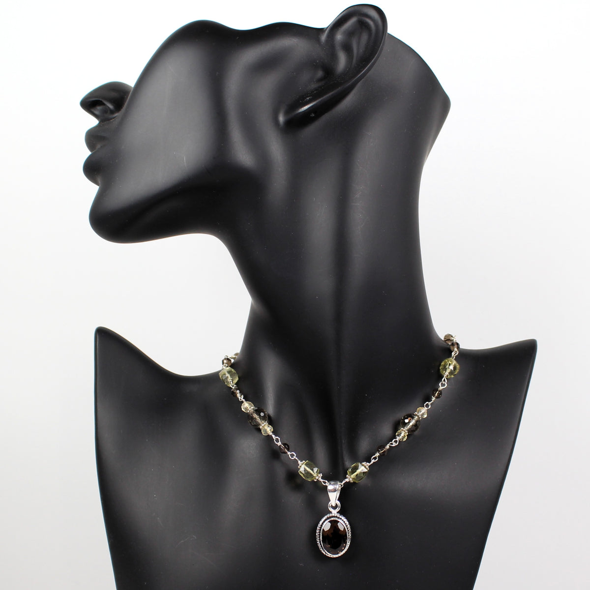 Faceted smoky quartz sterling pendant and hand wrapped faceted brown and yellow gemstones.