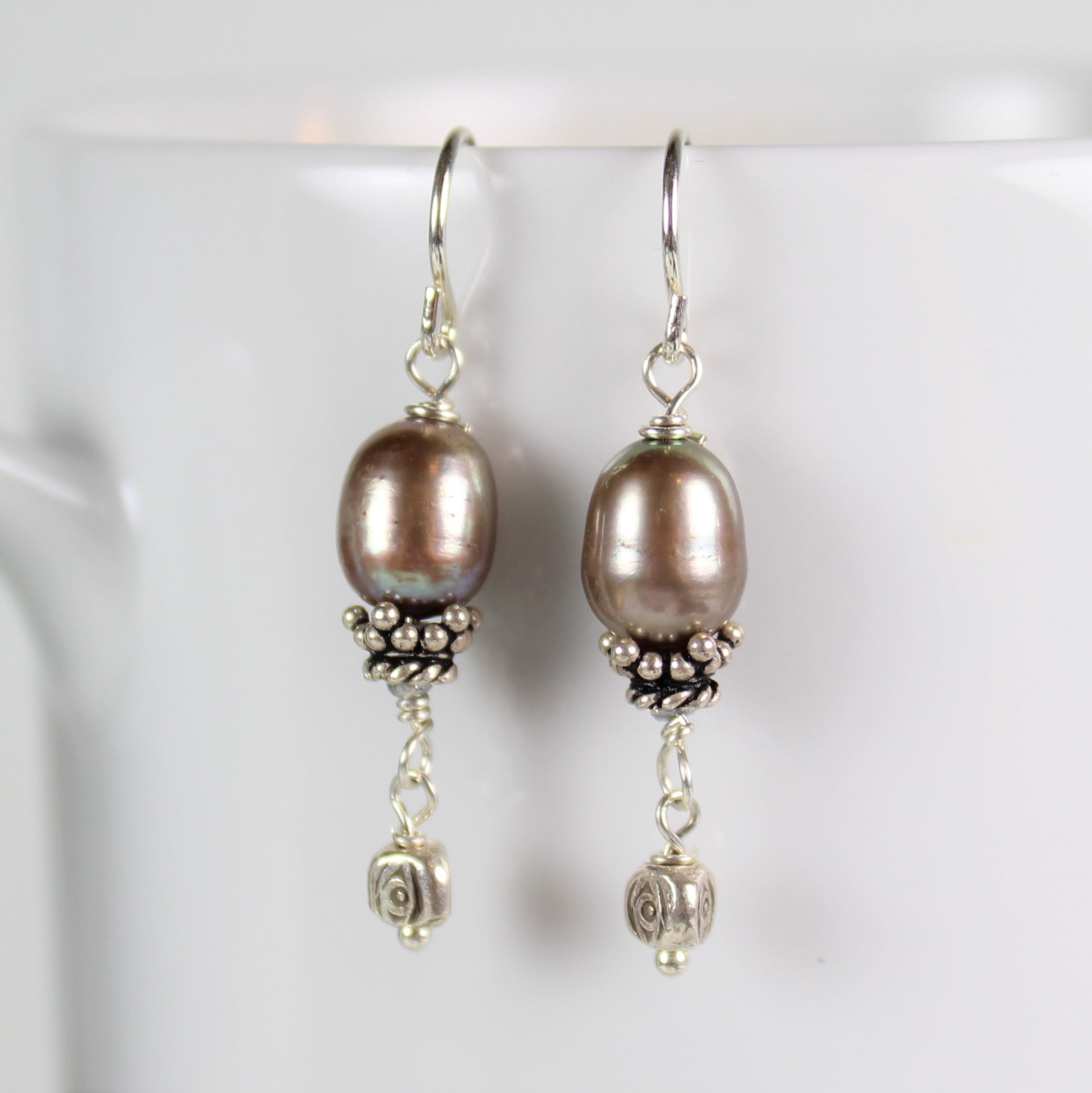 Sterling silver and beige freshwater pearl drop earrings feature hill tribe bead and bali silver bead cap