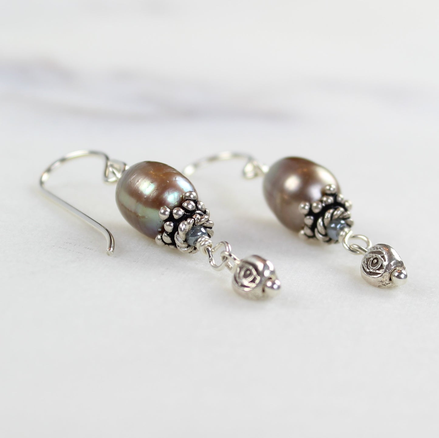 Sterling silver and beige freshwater pearl drop earrings feature hill tribe bead and bali silver bead cap