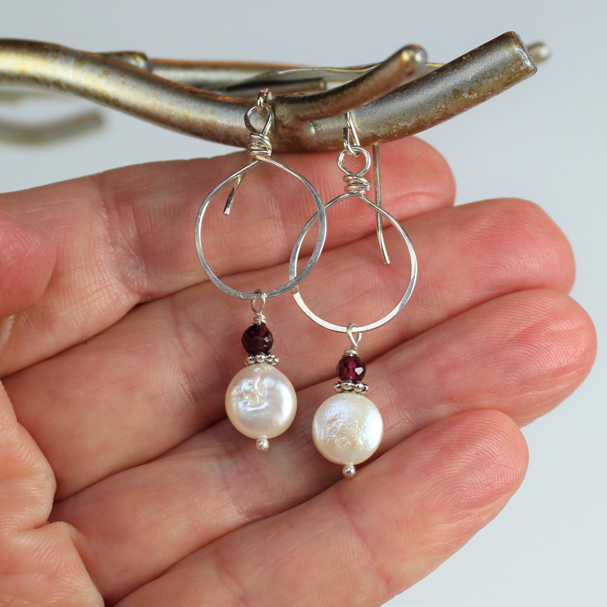 white coin freshwater pearl dangles off of hammered sterling loop on wire drop earrings