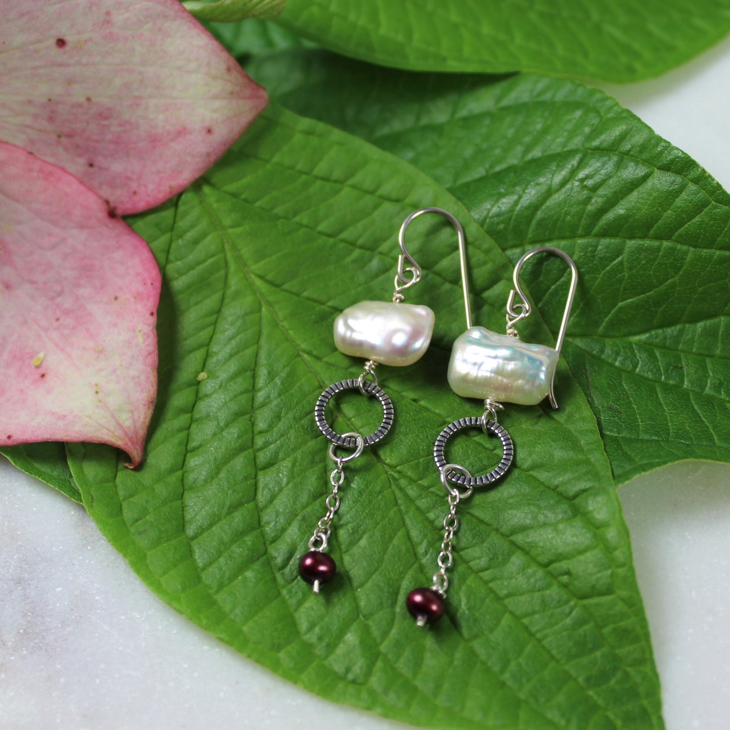 Fashion earrings feature sterling wires, freshwater pearls, sterling oxidized ring and chain