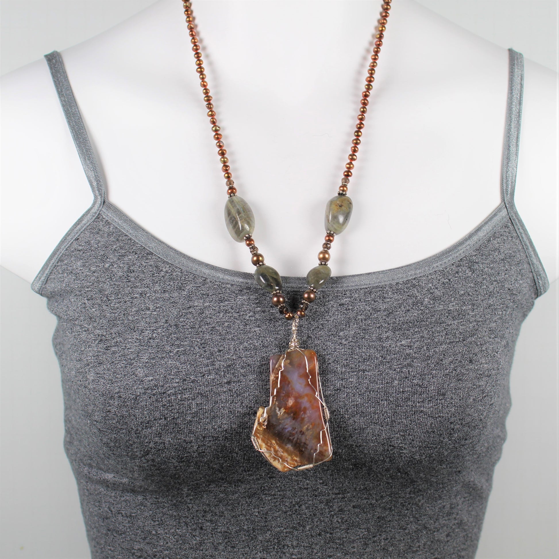 One of a kind agate slice wrapped in sterling silver wire dangles off of copper pearl necklace with labradorite accents.