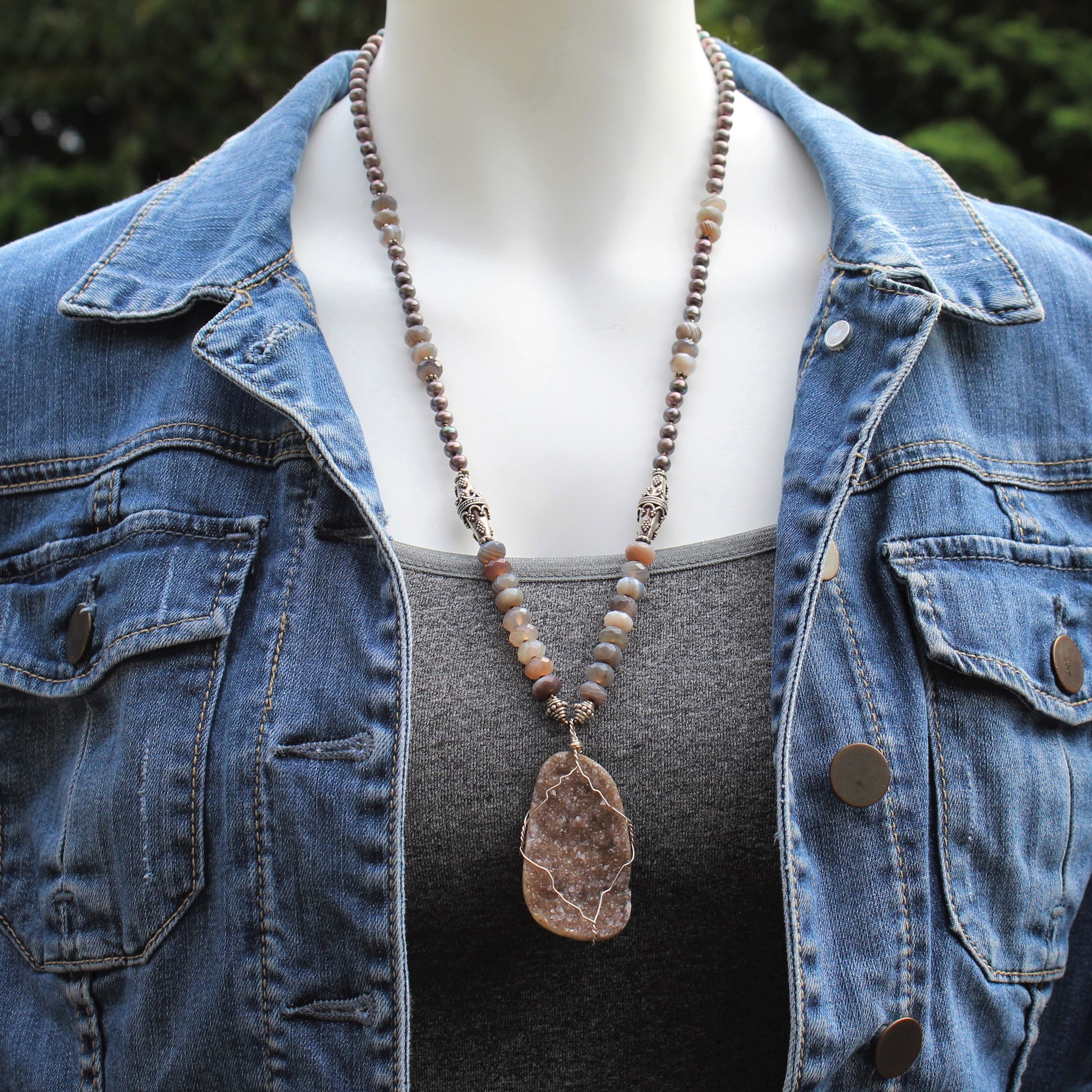 25 inch long mauve pearl and Botswana agate necklace features bali sterling silver beads and a wire wrapped druzy pendant.