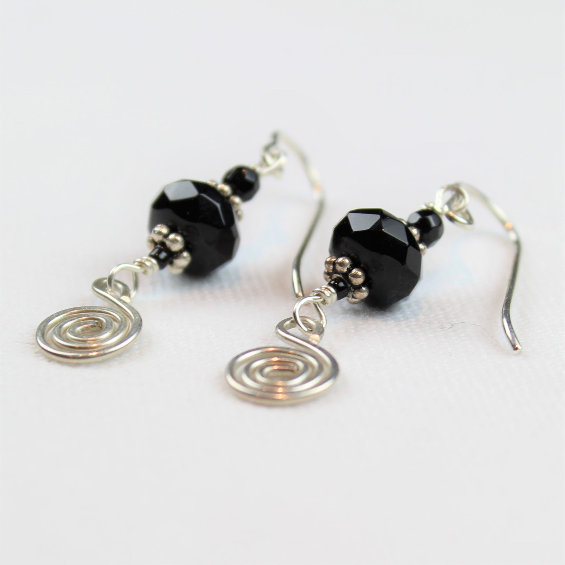 silver wire dangle earrings with black onyx and hammered sterling spiral drop