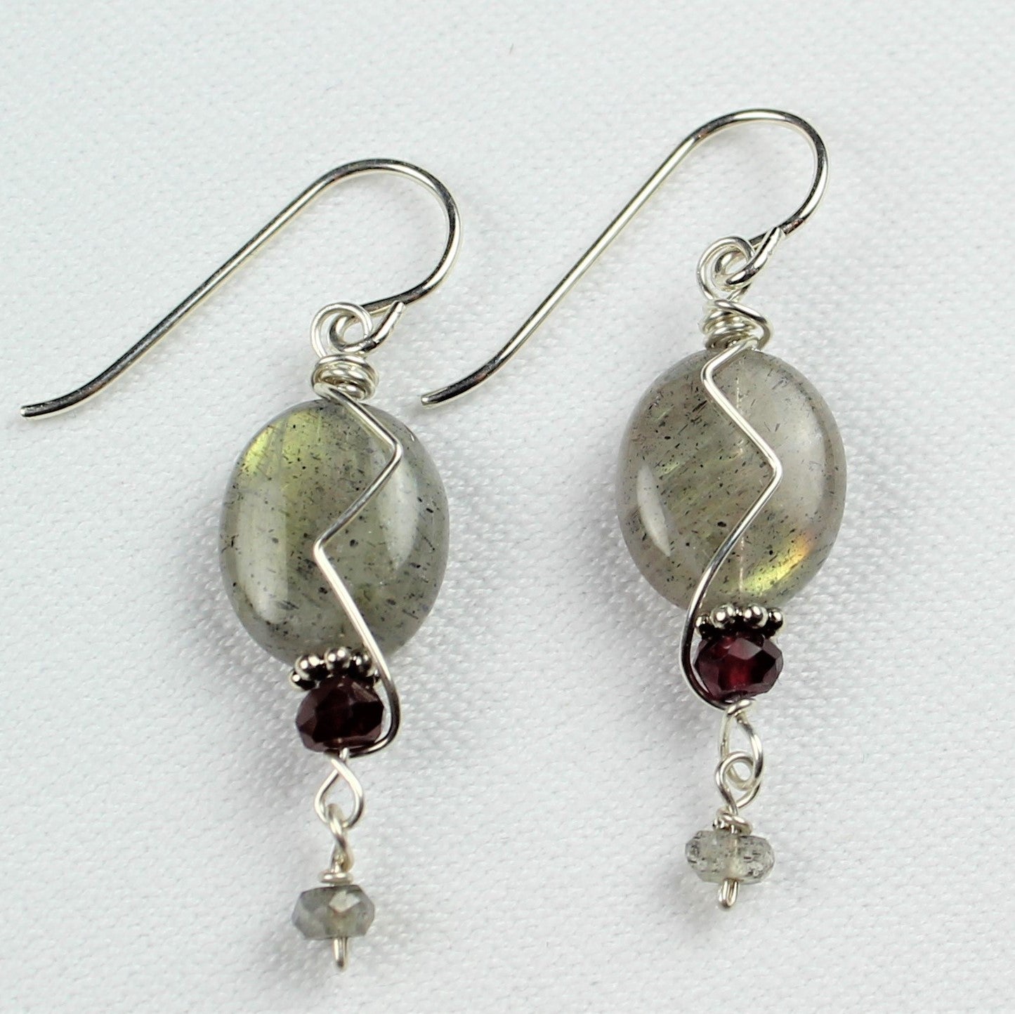 smooth iridescent labradorite oval earrings with garnet and small labradorite dangle