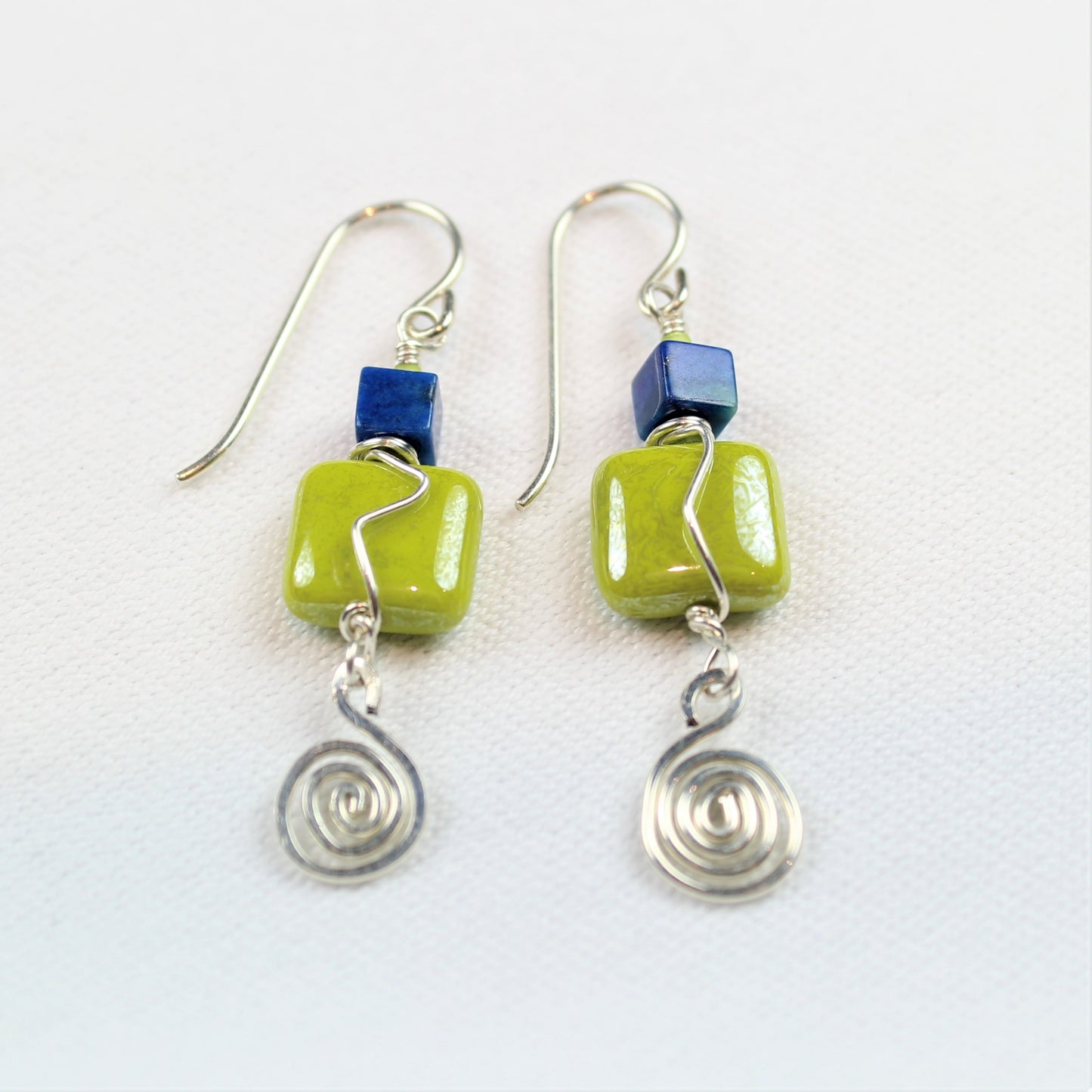 sterling silver hammered spirals dangle off of green glass and lapis square earrings