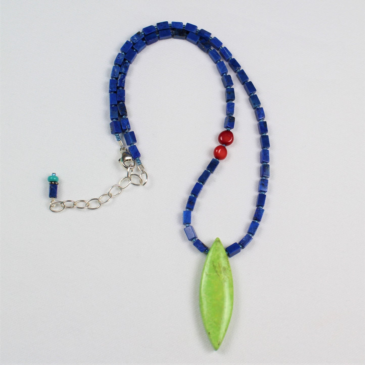 Dark blue square lapis beads and pointed oval bright lime green stone pendant on 15 inch long casual necklace