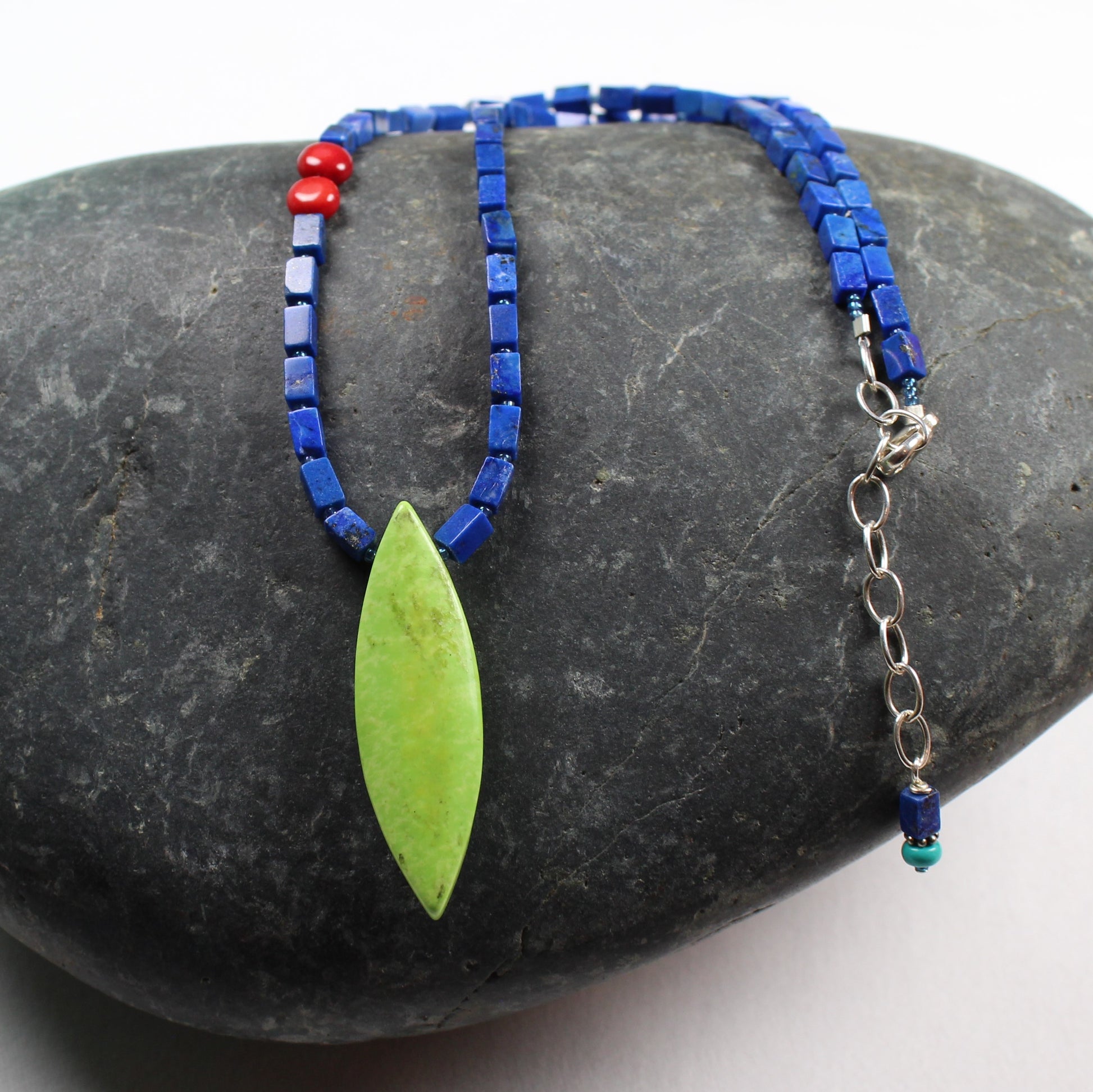 15 inch long asymmetrical necklace of square lapis gemstones and a pointed oval bright lime green stone.