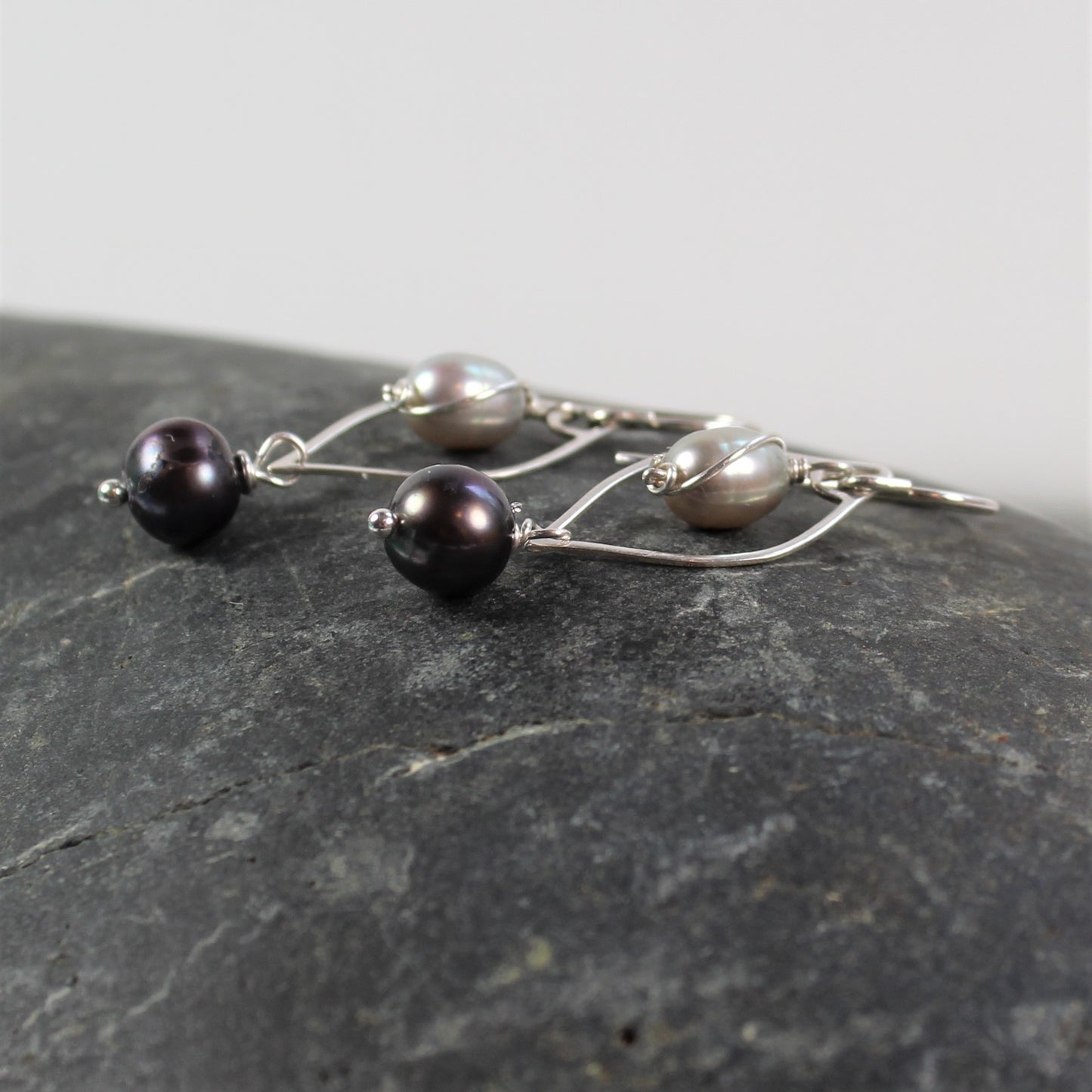 Curvy 1 1/2 inch sterling wire drop with light and dark gray freshwater pearls.