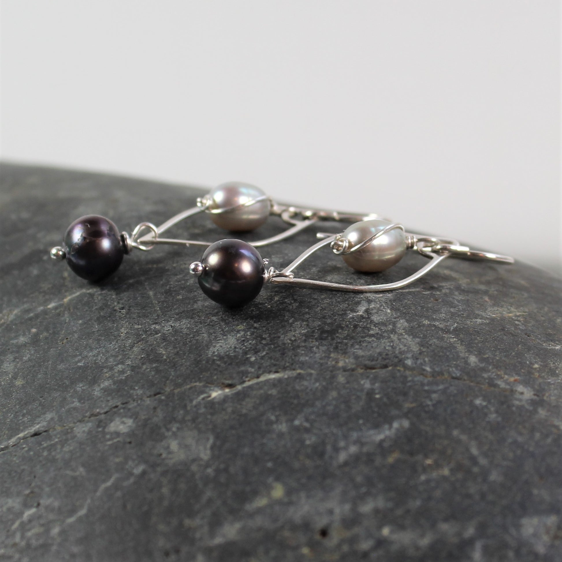 Curvy 1 1/2 inch sterling wire drop with light and dark gray freshwater pearls.