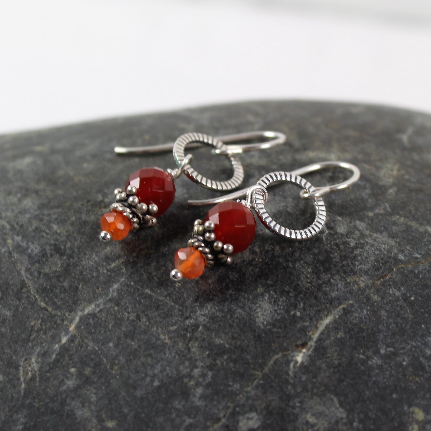 1 1/2 inch carnelian faceted earrings with bali silver bead cap and antiqued notched sterling loop